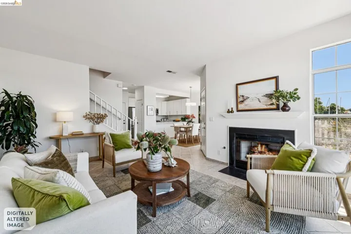 Bright living area featuring a fireplace with a white mantel and dark hearth