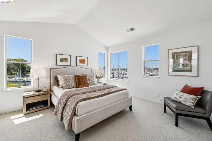 Vaulted ceilings complement multiple windows showcasing marina scenery