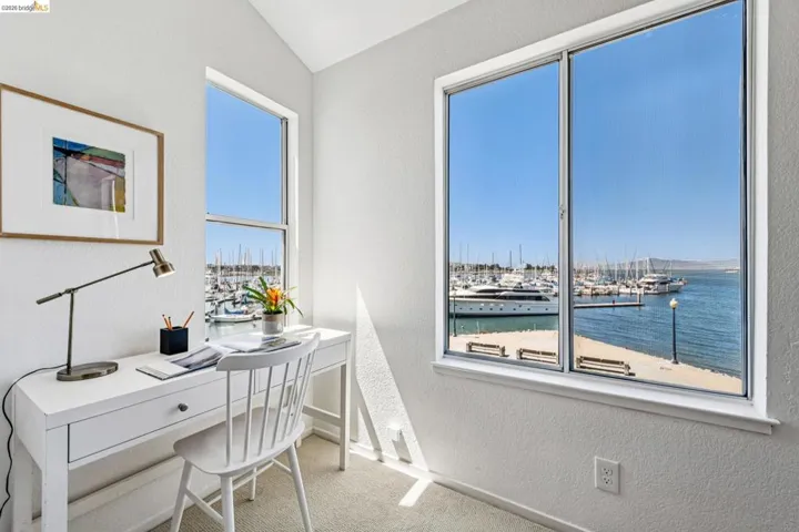 Bright interior space featuring dual windows, harbor scenery, and textured walls
