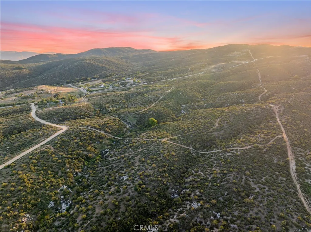 Elevated aerial perspective of the property and surrounding Landscape.