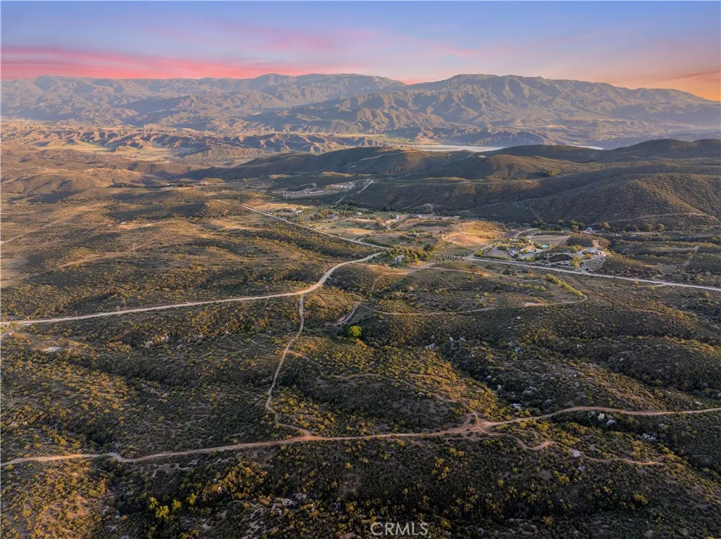 Panoramic aerial view, showcasing the surrounding valleys, rolling Hills and dramatic mountain backdrop