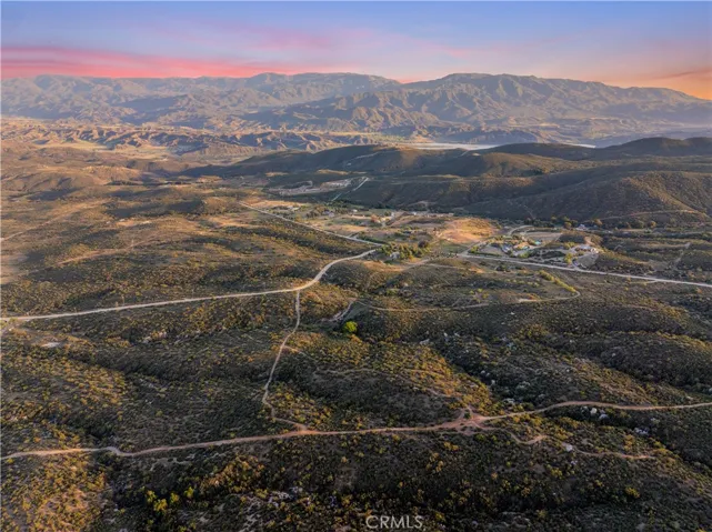 Panoramic aerial view, showcasing the surrounding valleys, rolling Hills and dramatic mountain backdrop