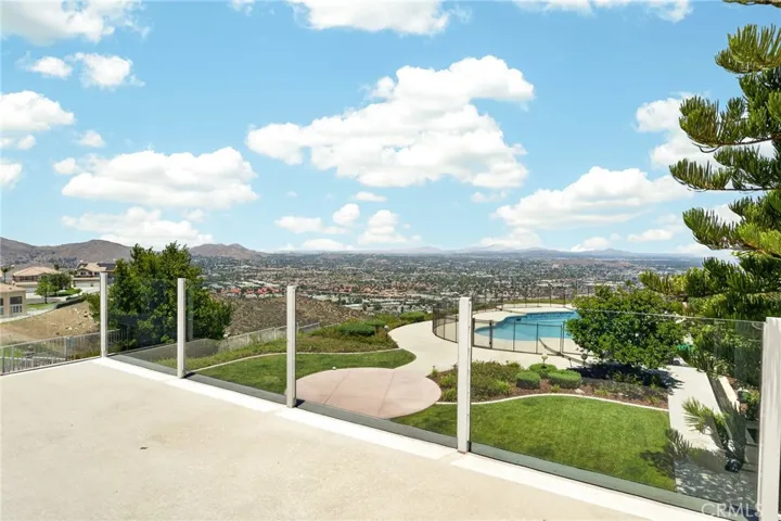 Balcony view of pool and city from primary bedroom 16318 sun summit drive, riverside, california 92503