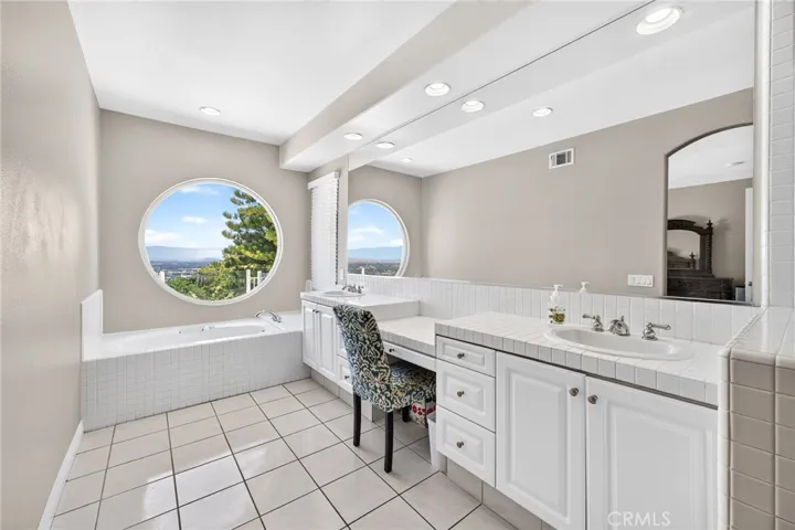 Primary bathroom with tub, dual sinks and view 16318 sun summit drive, riverside, california 92503