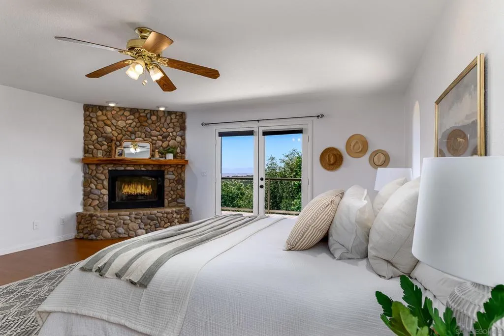 Primary Bedroom with fireplace and french doors to deck