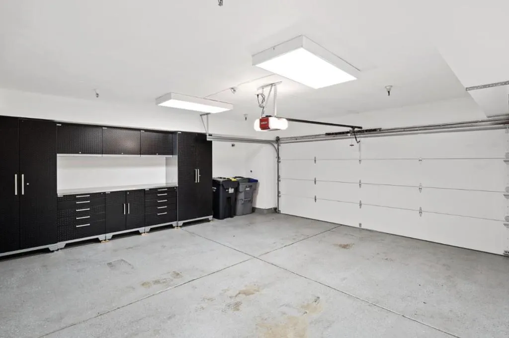 Sheetrocked garage with storage unit.