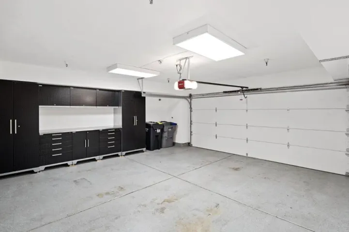 Sheetrocked garage with storage unit.