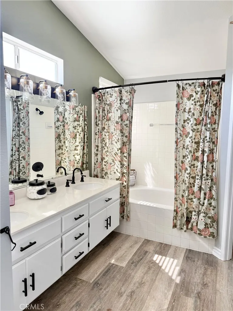 Master Bathroom is so spacious with tub/shower, double sinks with black widespread sink faucets, white vanity cabinets with black cabinet hardware and cultured marble vanity top.
