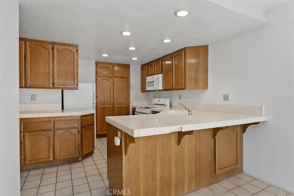 Large kitchen with wood cabinets and spacious countertops.