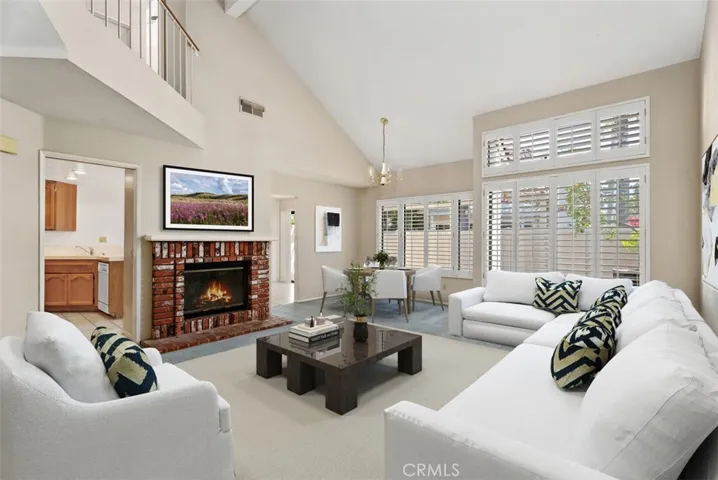 Large living room with cozy fireplace & dining area.
Note: This photo is virtually staged.