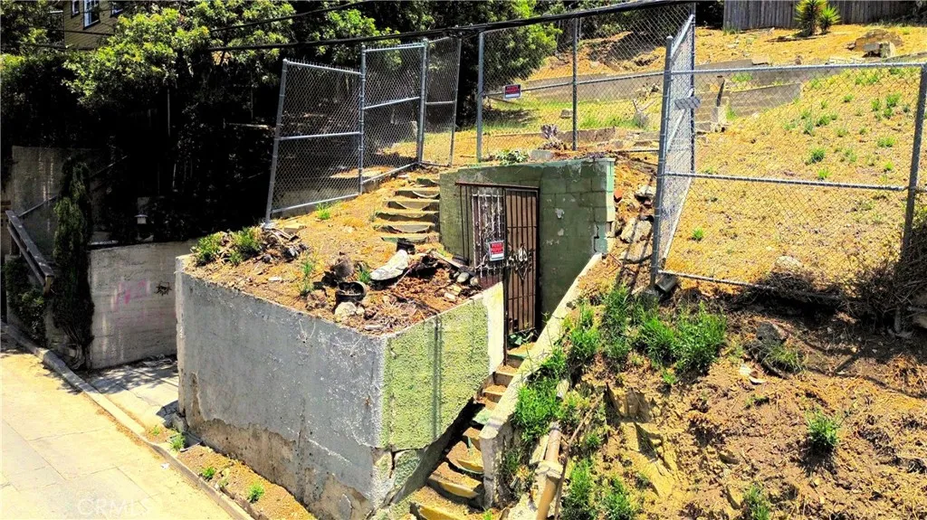 Street View of garage and stairs to entrance of the lot