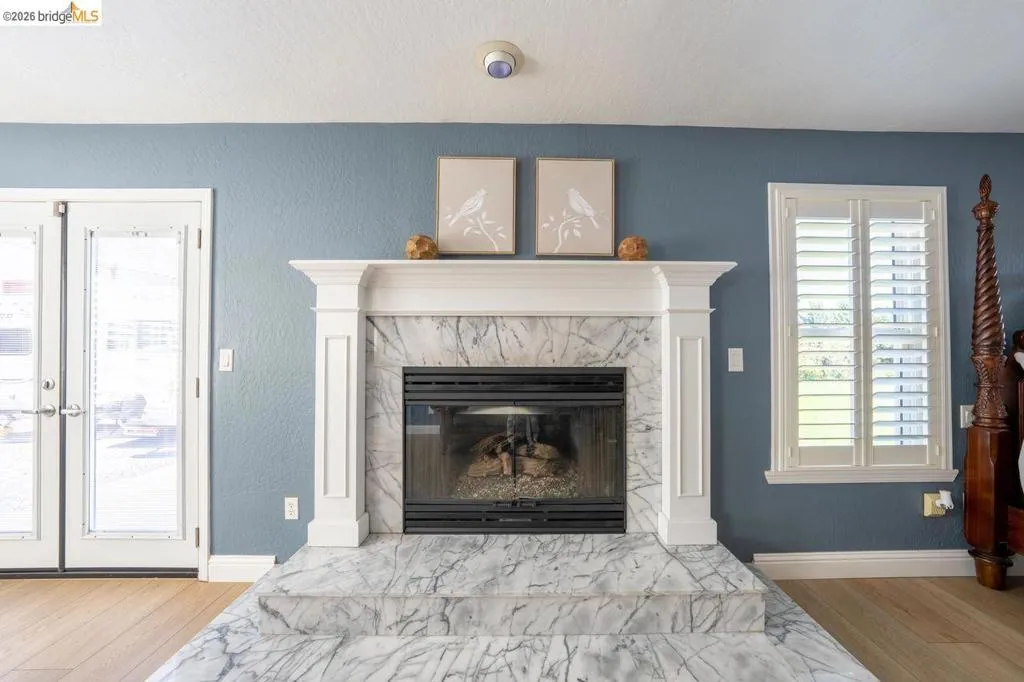 Fireplace with a white marble surround and hearth