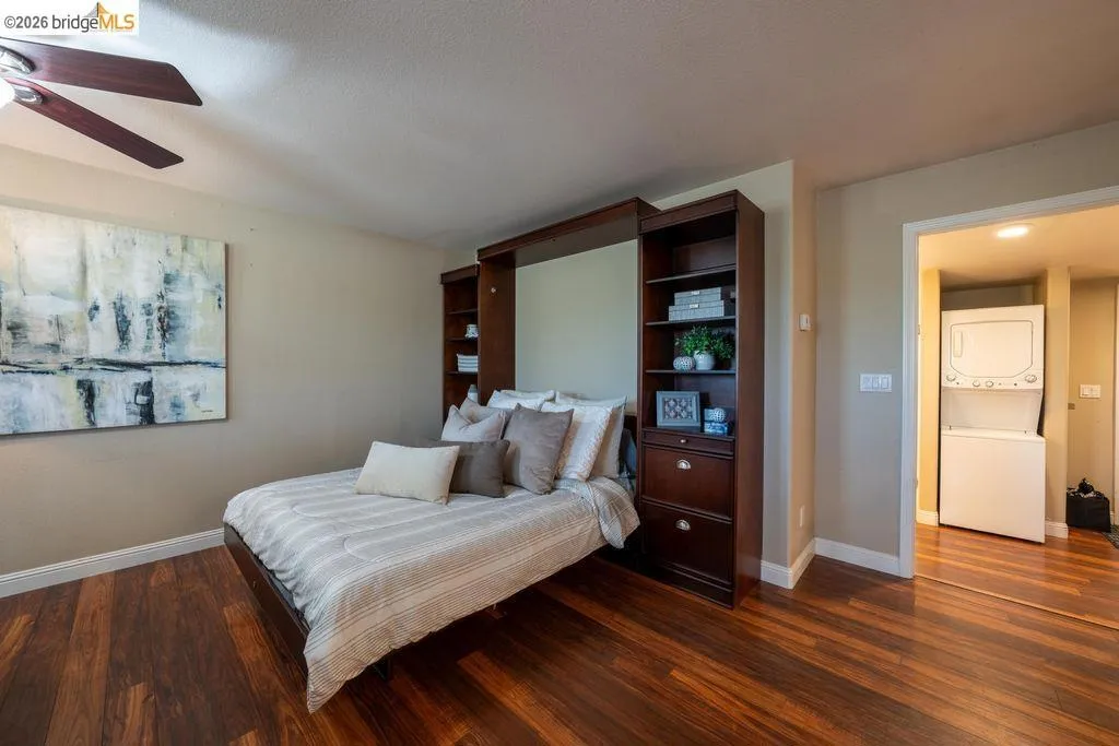 Hardwood-finish flooring throughout, featuring a built-in dark wood cabinetry system