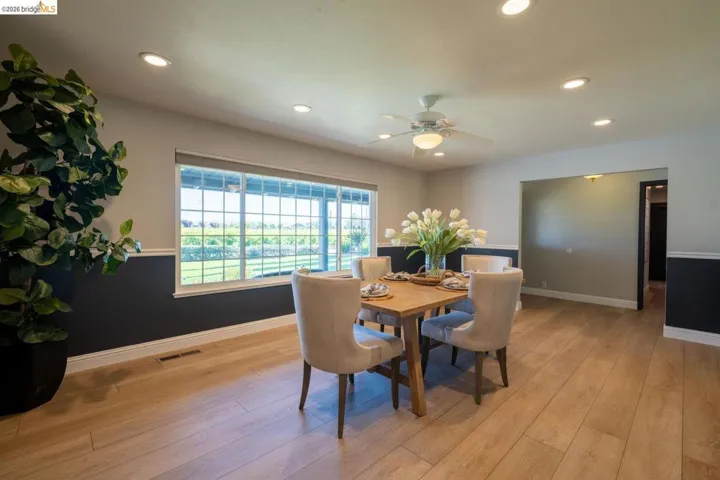 Dining area with wood-finish flooring, recessed lighting, and a ceiling fan