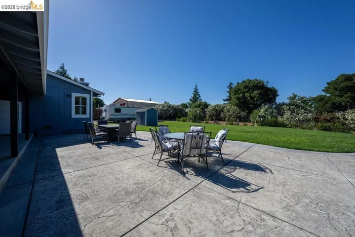 Expansive stamped concrete patio with direct access to a manicured lawn