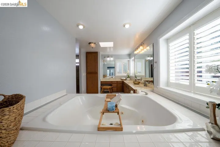 Soaking tub with white tile surround