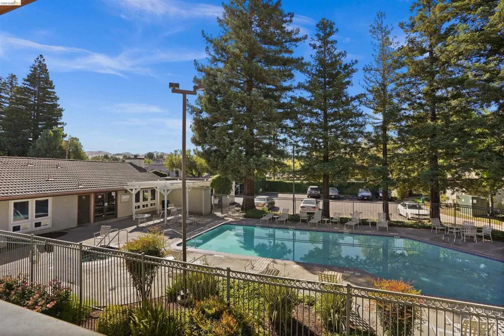 Outdoor swimming pool surrounded by a paved patio area
