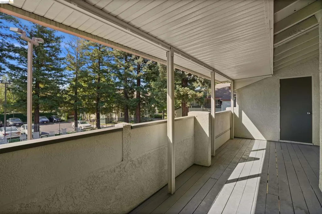 Covered outdoor deck with wood-finish flooring