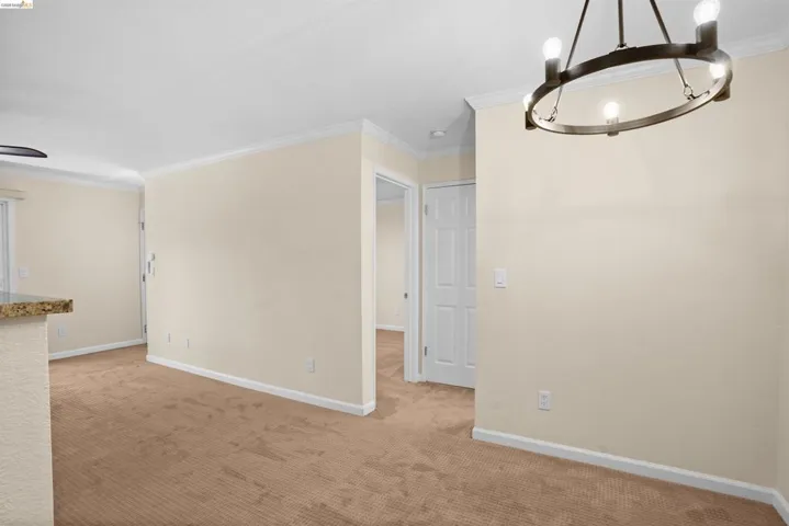 Room featuring neutral carpet flooring and light-toned walls