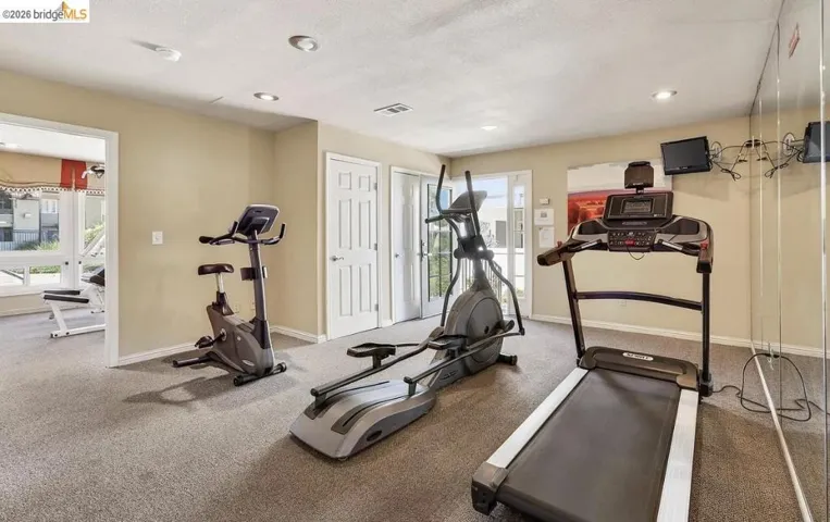 Dedicated fitness space featuring carpet flooring and recessed lighting