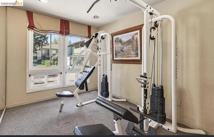 Dedicated fitness space featuring neutral wall tones, recessed lighting, and grey carpeting