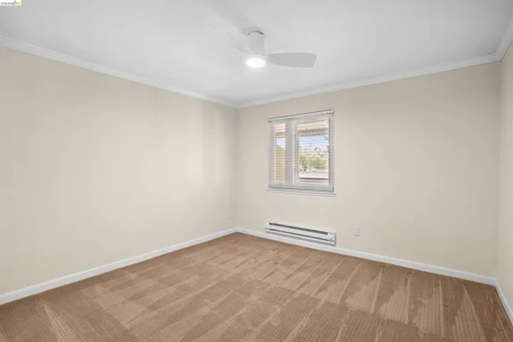 Neutral-toned walls complement the carpeted flooring