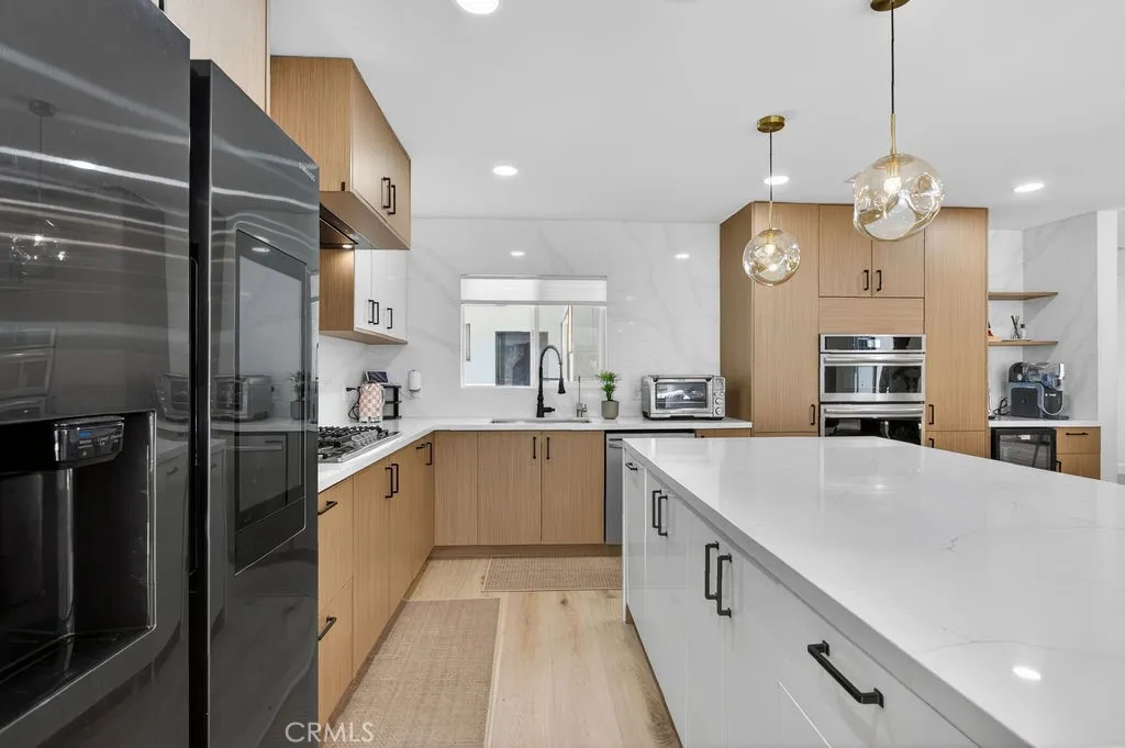 Modern kitchen featuring sleek finishes and a white accent color on the center island.