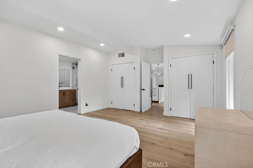 Primary bedroom featuring three closets