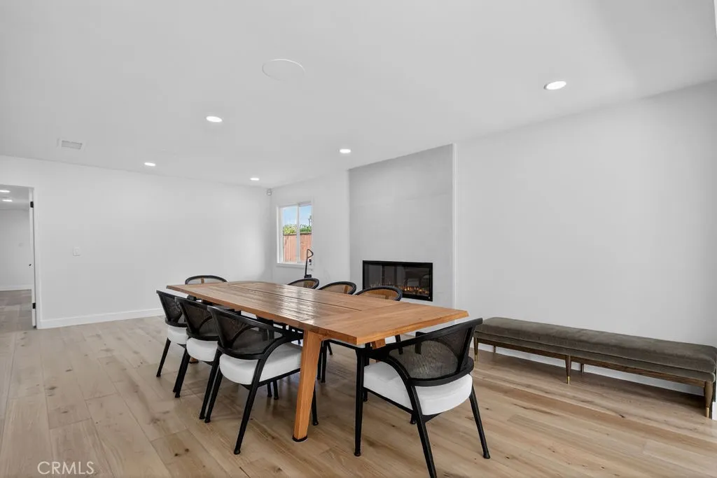 Bright and spacious dining area featuring a modern fireplace.