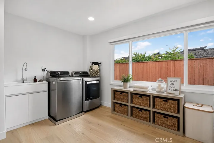 Huge laundry room with new flooring and appliances.