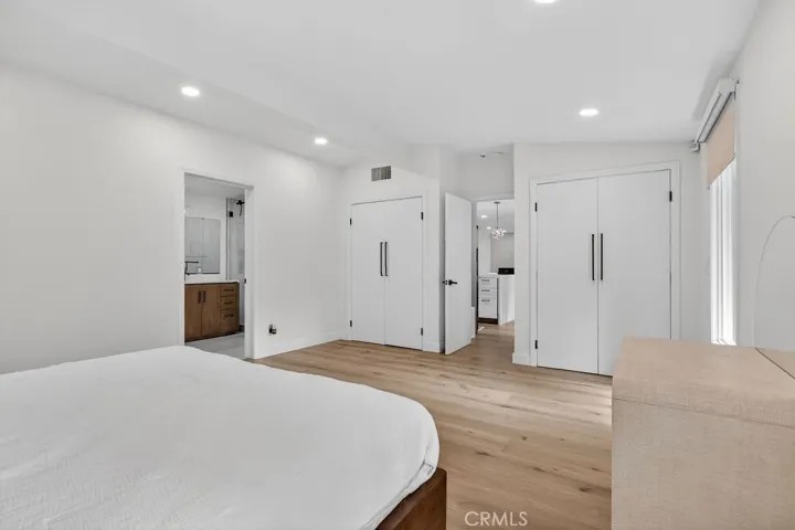 Primary bedroom featuring three closets