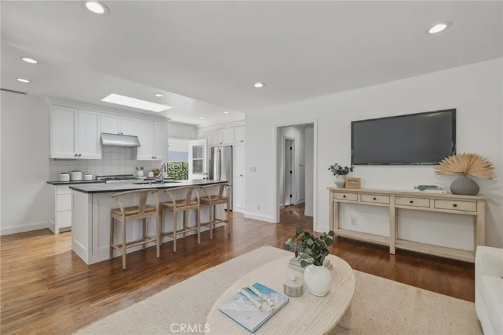 light and bright living room opens to kitchen