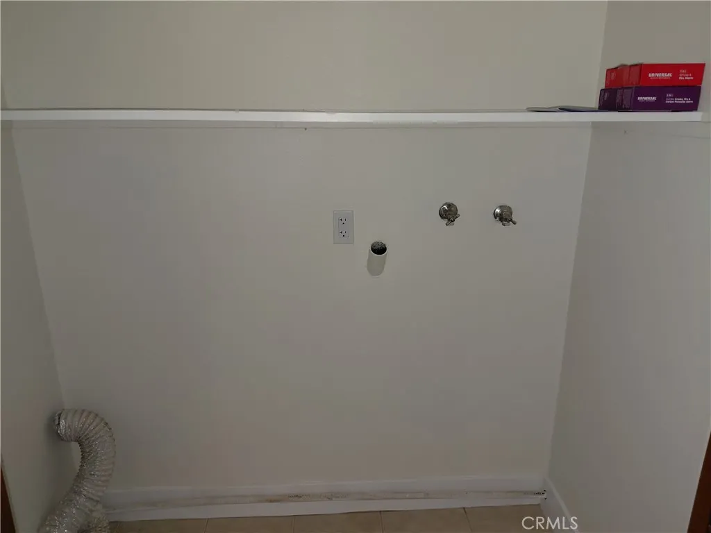 Indoor laundry hookups behind folding doors in kitchen