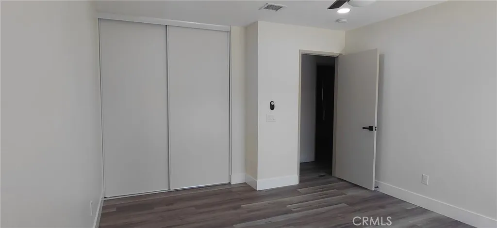 In primary bedroom looking toward entrance doorway and closets