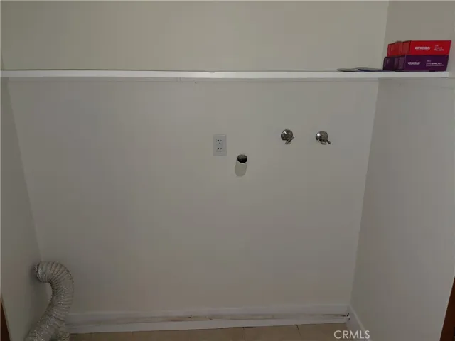 Indoor laundry hookups behind folding doors in kitchen