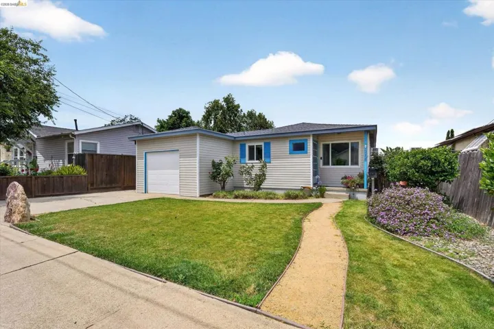 Single-story residence featuring light-toned siding and a contrasting blue trim