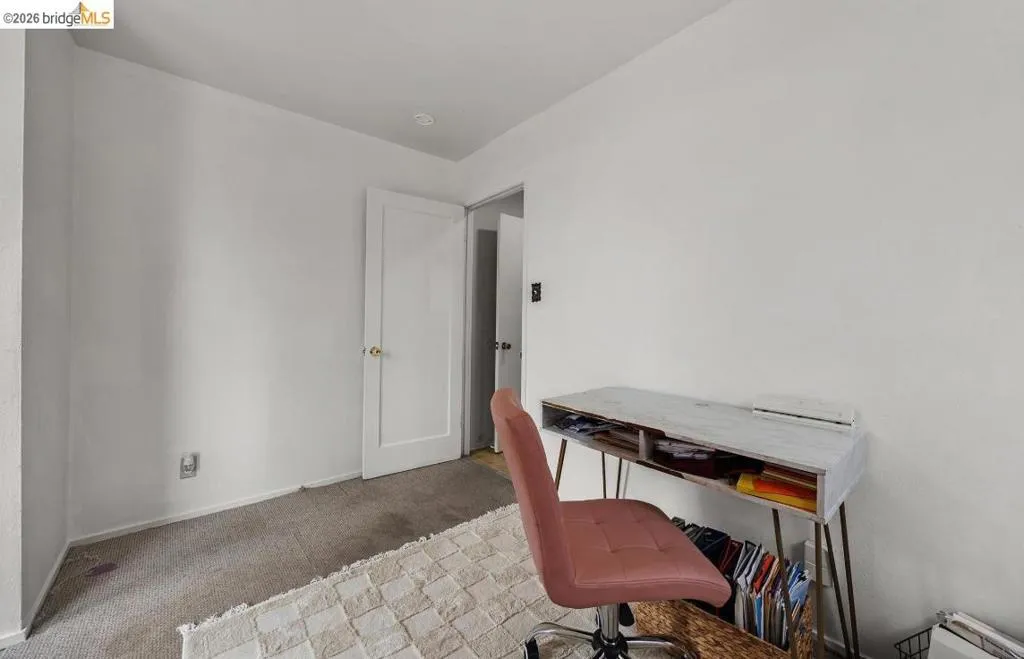Bright room featuring white painted walls and neutral carpet flooring