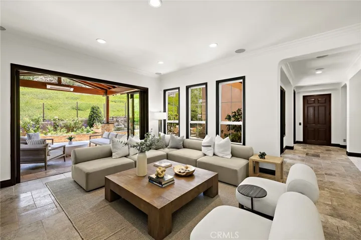 large great room that opens to the outside loggia