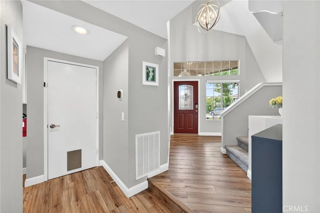 Hallway going to front door, garage and stairs