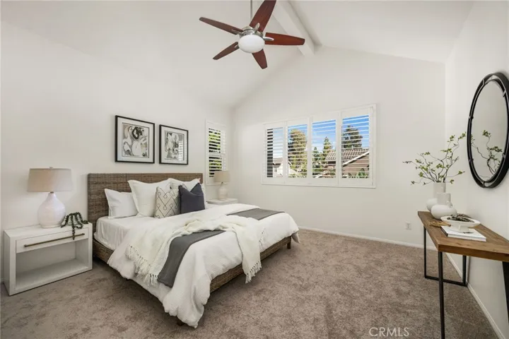 Primary bedroom with vaulted ceilings