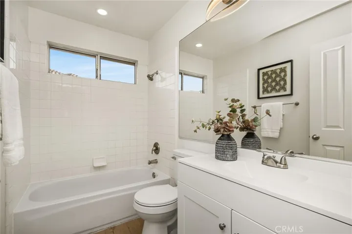 Hall bath with white shaker cabinet