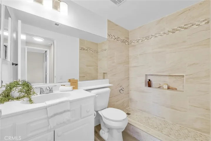 Remodeled shower with designer tile and updated light fixtures