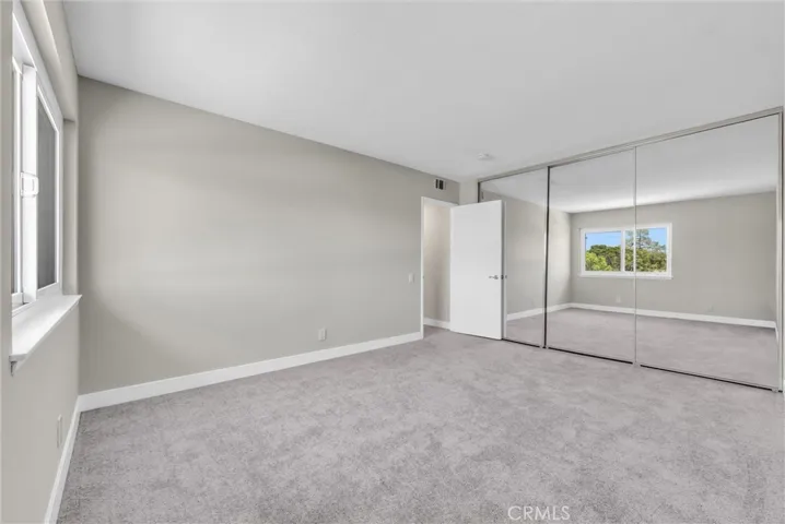 Large bedroom with a wall to wall closet
