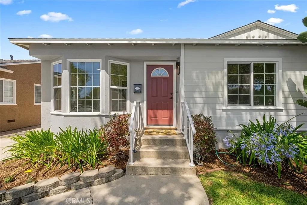 A cheerful pop of color draws you in, highlighting the home's freshly painted exterior and charming curb appeal.
