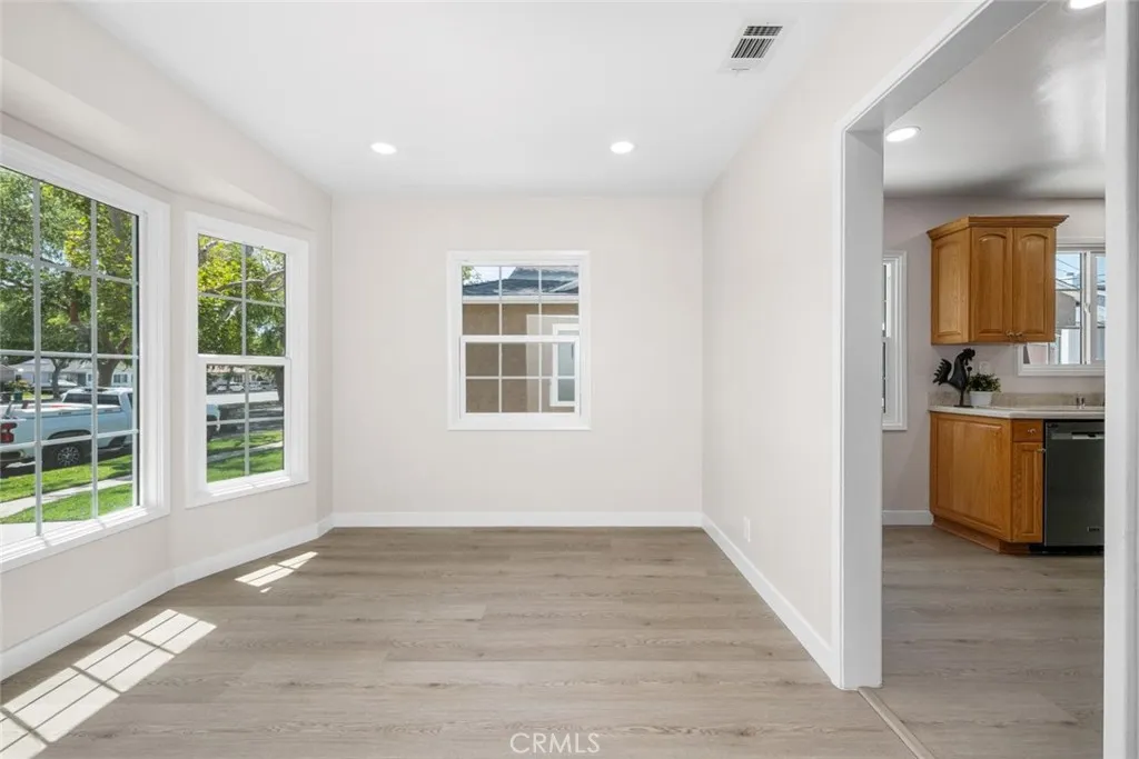 A sun-filled bay window bathes the dining area in natural light.