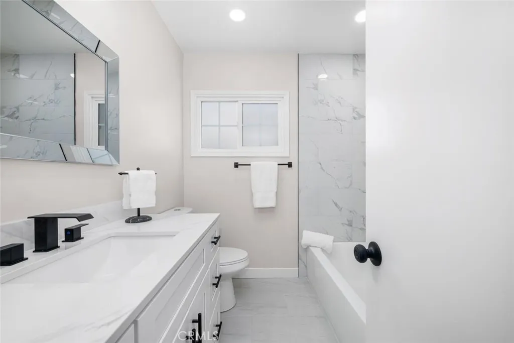 Guests and residents alike will appreciate the stylishly remodeled hallway bathroom.
