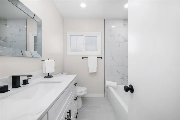 Guests and residents alike will appreciate the stylishly remodeled hallway bathroom.