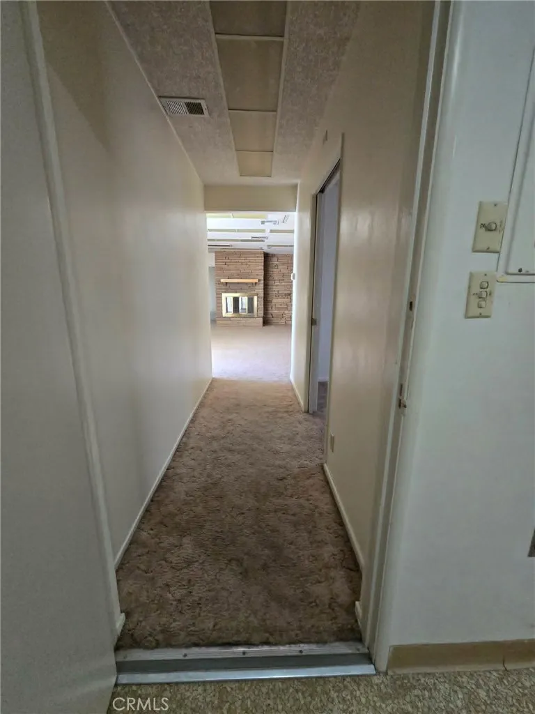 2nd hallway, leads to den/2nd living room w/bathroom and 2 other bedrooms, one with a bathroom
