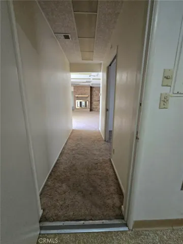 2nd hallway, leads to den/2nd living room w/bathroom and 2 other bedrooms, one with a bathroom