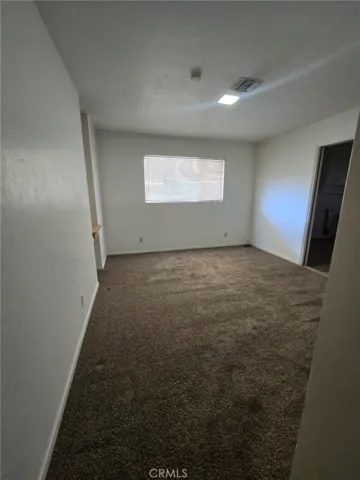 First bedroom to the right down main hallway. Has 2 doors, one from main hallway and other leading to laundry/utility room and den/2nd living room
